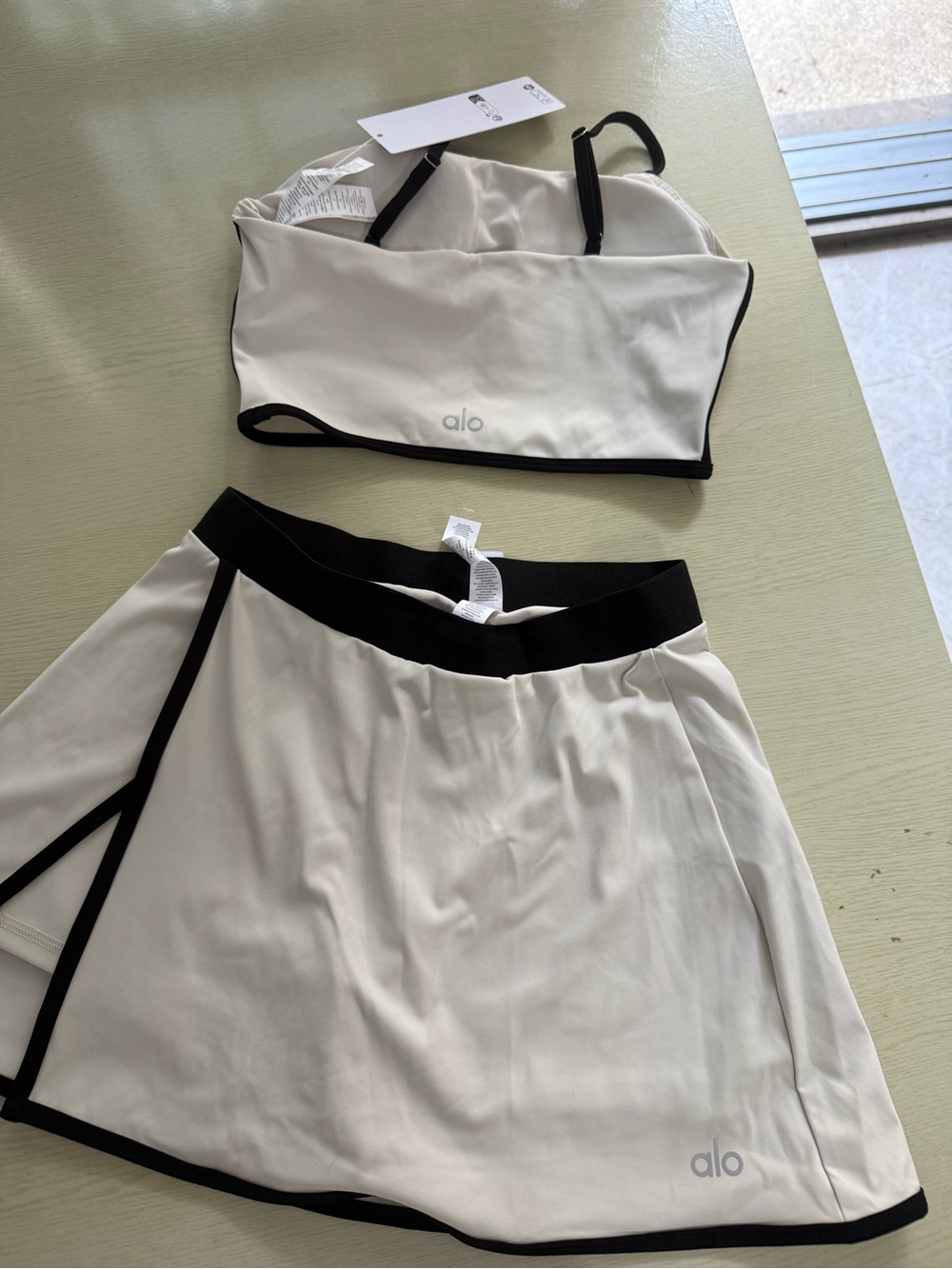 ALO Yoga Cream Sports Bra and Skort with Black Trim - Picture 2 of 6